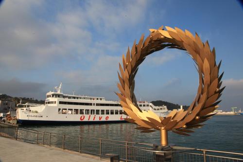 a large cruise ship is docked in the water at Takamatsu Tokyu REI Hotel in Takamatsu