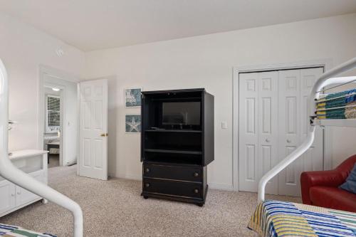 a bedroom with a tv on a dresser at CCHK70 Peace of Paradise in Corolla