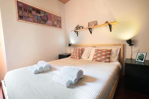 a bedroom with a bed with towels on it at Casa Castello - 20 min by train to Florence in Prato