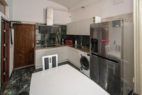 a kitchen with a stainless steel refrigerator and a dishwasher at The Grand Royal 3BDR Heart of Old Town in Prague