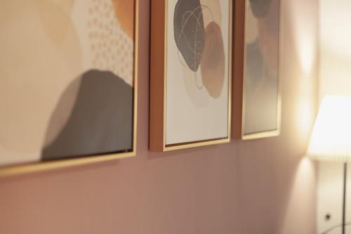 two framed pictures on a wall next to a lamp at 島隅慢旅 in Xiaoliuqiu