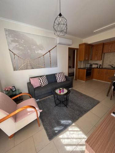 a living room with a couch and a table at 2 Bedroom Apartment, Zygos Centre Block D - By IMH Travel & Tours in Paphos City