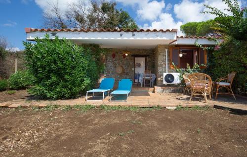 a group of chairs sitting on a patio at 1 Bedroom Cozy Home In Joppolo in Ioppolo
