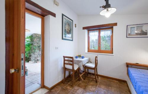 a bedroom with a table and chairs and a bed at 1 Bedroom Cozy Home In Joppolo in Ioppolo