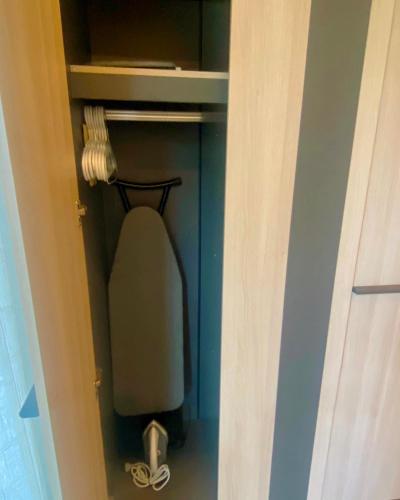 a room with a closet with a chair in it at ONYX Cafe and Hostel - Betong in Betong
