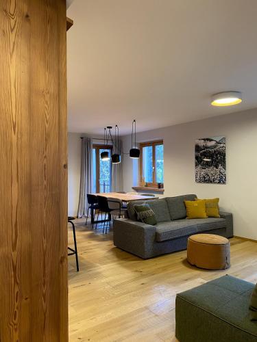 a living room with a couch and a table at La Primula in Pragelato