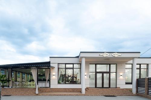 a rendering of a house with large windows at Complex Pescăresc Gura Repezii Borșa in Borşa