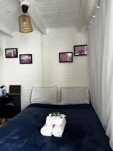 a bedroom with a bed with towels on it at Casa do Point in Saquarema