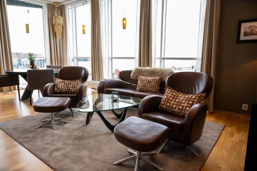 a living room with a couch and chairs and a table at Hotel Frøya in Sistranda