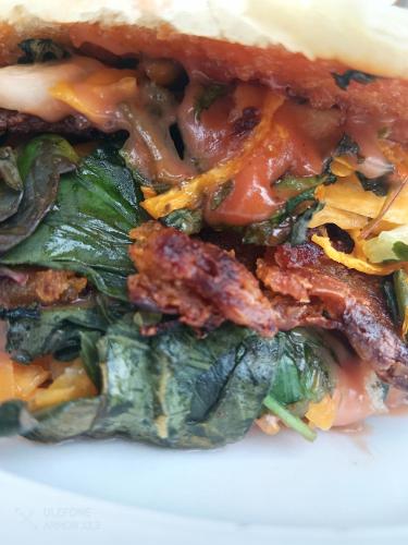 a close up of a sandwich with cheese and spinach at Vanista Dica- Dancing Bamboo in Isle