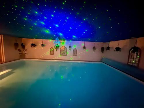 a swimming pool with a ceiling filled with stars at B&B Wellness Soest in Soest
