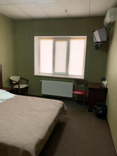 a hospital room with a bed and a window at Центр автотуризму М12 in Krasnopolka
