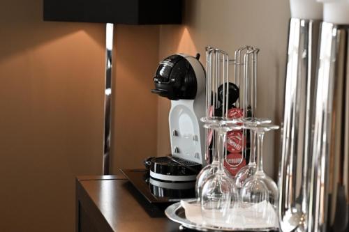 a kitchen counter with a mixer and wine glasses at Hotel Frøya in Sistranda