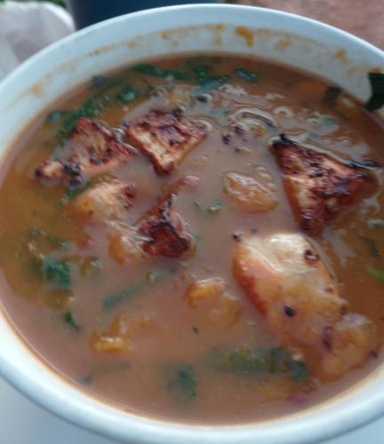 a bowl of soup with chicken and vegetables in it at Vanista Dica- Dancing Bamboo in Isle