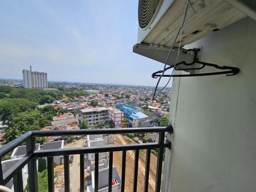 a view of a city from the balcony of a building at Apartemen Green Lake View Ciputat by Twin Property in Pondokcabe Hilir