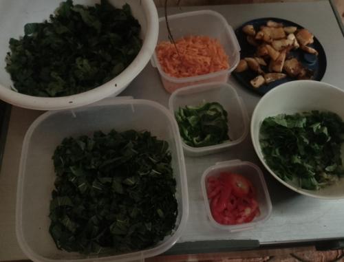 a table with four plastic containers filled with vegetables at Vanista Dica- Dancing Bamboo in Isle