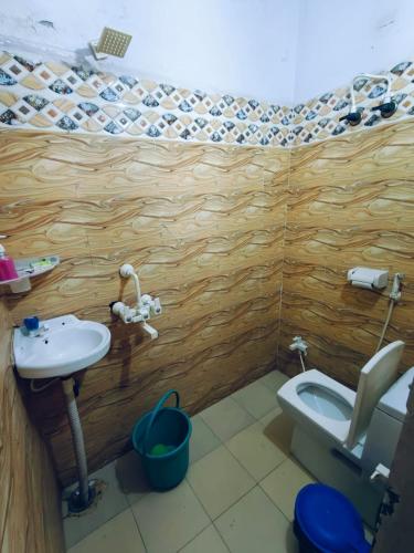 a small bathroom with a toilet and a sink at Milestone Homestay Agra in Tājganj