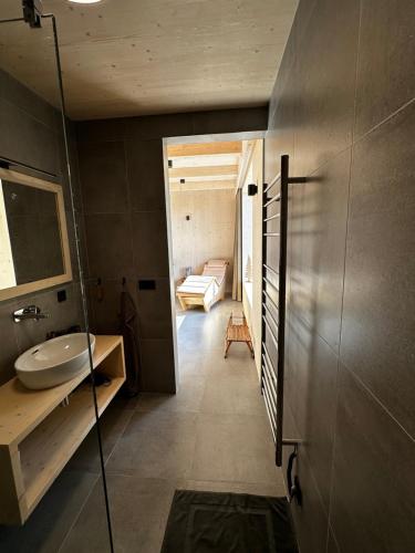 a bathroom with a sink and a bed in a room at Villa Chalet Bledule-wellness & sauna in Roprachtice