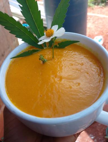 a cup of soup with a flower on top of it at Vanista Dica- Dancing Bamboo in Isle