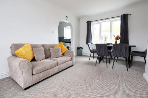 a living room with a couch and a table at Escape to Comfort 3BR in Avonmouth