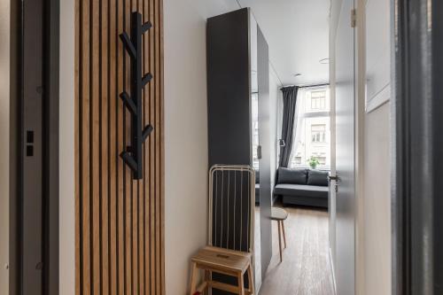 a hallway with a radiator and a room with a bed at Hook Studios Vilnius Old Town Economy in Vilnius