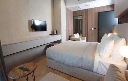 a hotel room with a bed and a tv at Keta Hotel & Spa - Mavrovo in Mavrovo