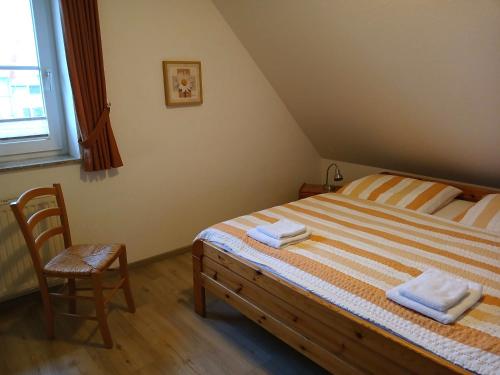 a bedroom with a bed with two towels on it at Ferienhof Christian und Antje Hopp in Fehmarn