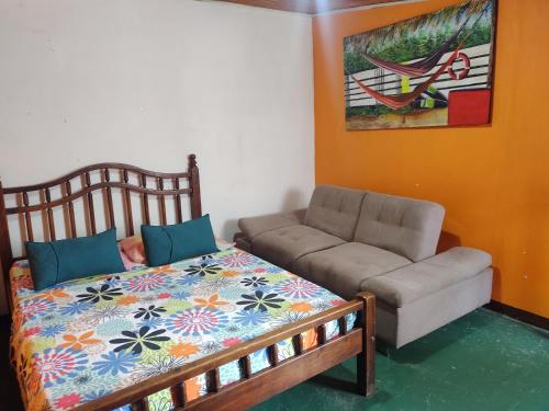a living room with a bed and a couch at Biohotel Caribe Green in Santa Marta