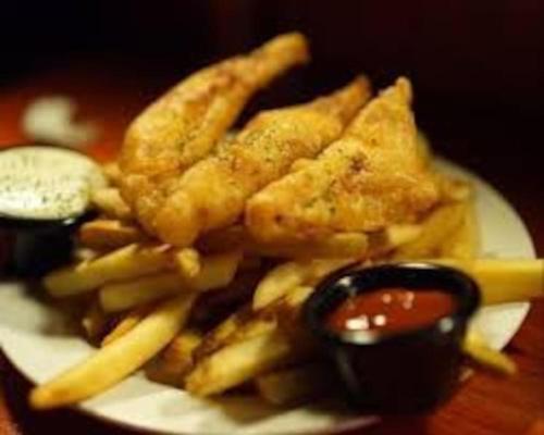 a plate of food with french fries and ketchup at The Retreat in Chelwood Gate