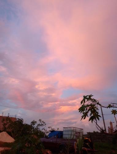 a truck parked under a cloudy sky at sunset at Vanista Dica- Dancing Bamboo in Isle