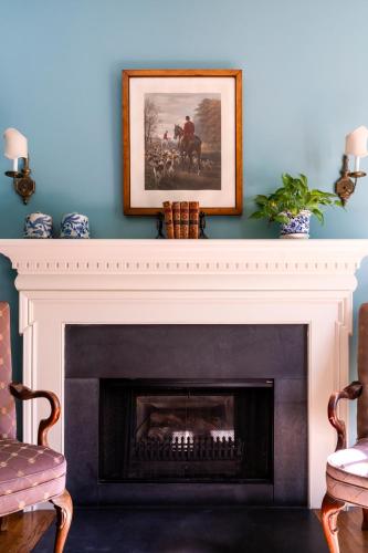 a living room with a fireplace with a picture above it at Francis Malbone House in Newport