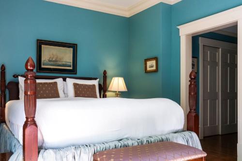 a bedroom with a white bed with blue walls at Francis Malbone House in Newport