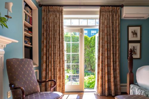 a living room with a window and a chair at Francis Malbone House in Newport