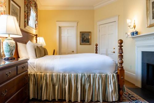 a bedroom with a bed and a fireplace at Francis Malbone House in Newport