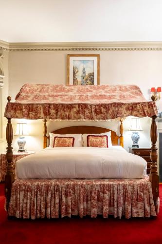 a bedroom with a large bed with a canopy at Francis Malbone House in Newport