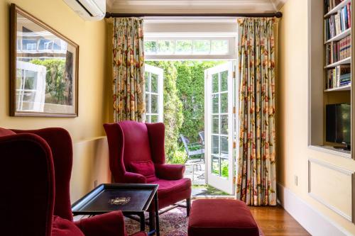 a living room with two chairs and a window at Francis Malbone House in Newport