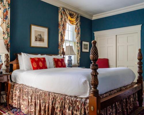 a bedroom with a large bed with blue walls at Francis Malbone House in Newport