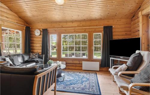 a living room with a couch and a tv at Holiday Home Blokhus 59 in Blokhus