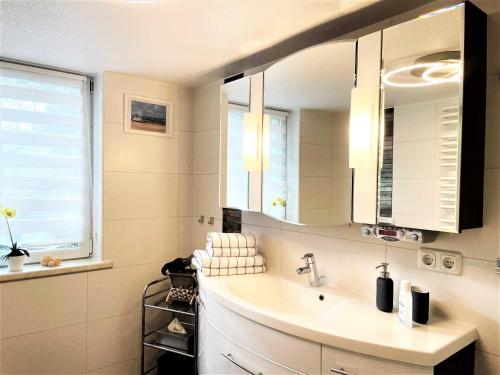 a bathroom with a sink and a mirror at Ferienhaus Zschieck in Torno