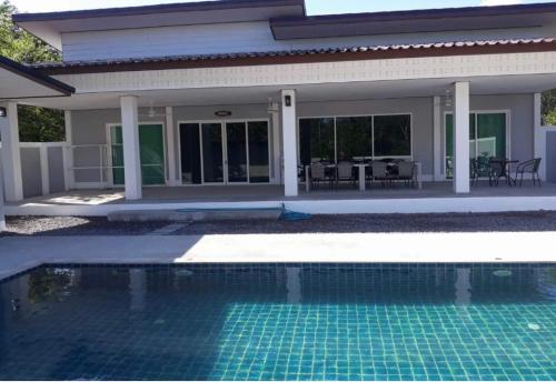 a swimming pool in front of a house at Kongsai Private poolvilla in Klong Khong in Ko Lanta Yai