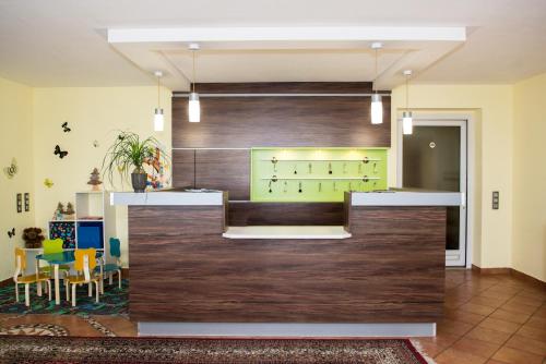 a lobby with a bar and a dining room at Gasthof-Pension Ölberger in Wolfsberg
