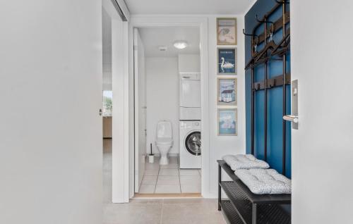 a bathroom with a toilet and a door leading into a room at Holiday Home Næsvej Iii in Assens