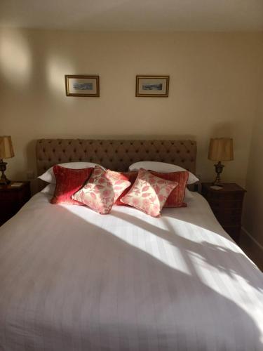 a bed with three pillows on top of it at Rusling House in Bristol