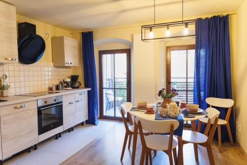 a kitchen and dining room with a table and chairs at Beautiful apartment old town Arkadenhof in Löbau