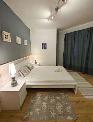 a bedroom with a large white bed and a rug at Hilltop Hideaway in Cospicua