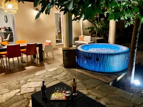 duży jacuzzi w pokoju ze stołem w obiekcie Villa Carletti à 3min des plages (7pers. - 3ch.) w mieście Oletta