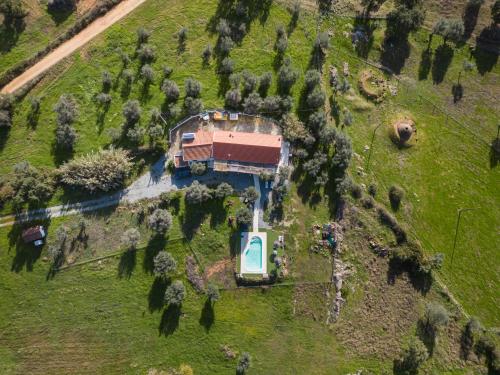 an aerial view of a house on a hill with trees at Monte da Masmorra de baixo-Casa Alentejana in Montemor-o-Novo