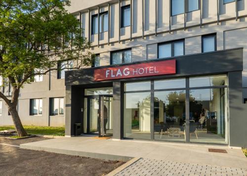 a large building with a sign for a taco hotel at Flag Hotel Lisboa Sintra in Sintra