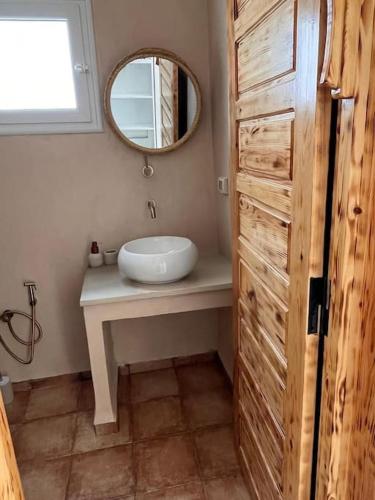 a bathroom with a sink and a mirror at Dar el Ànbar in Midoun