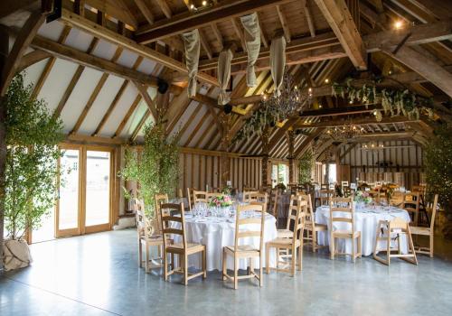 a dining room with tables and chairs in a barn at Rural Retreat near West Wittering Beach! Dog Friendly & Free Parking - Ideal Weekend Getaway! Chichester Holiday Properties in Donnington